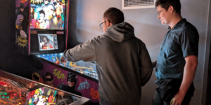 two men discussing pinball strategy