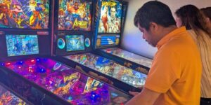A man playing pinball