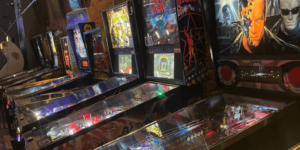 A line of pinball machines at an arcade bar