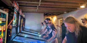 Players competing at a pinball tournament